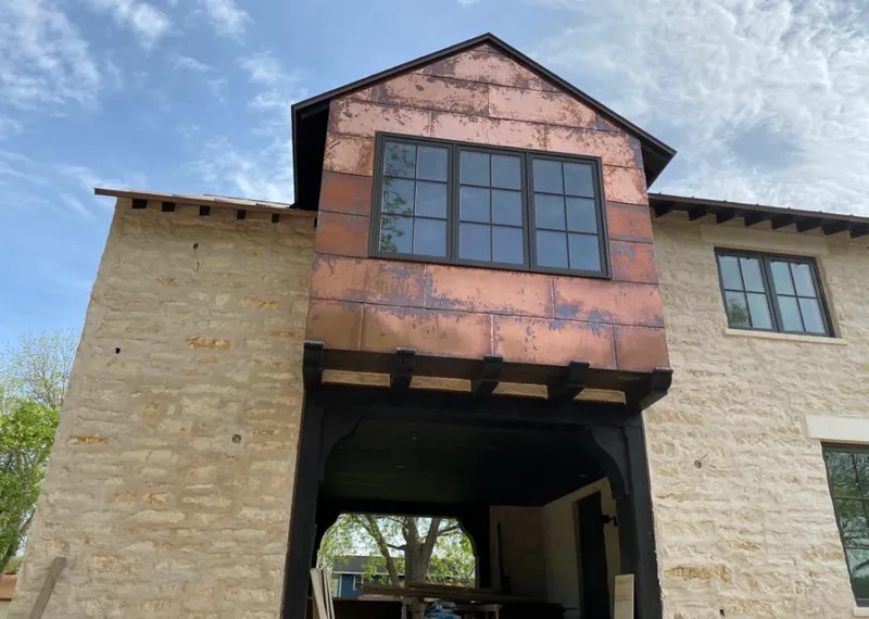 Copper metal panel facade on a stone building for Skylight Installation in Neptune Beach
