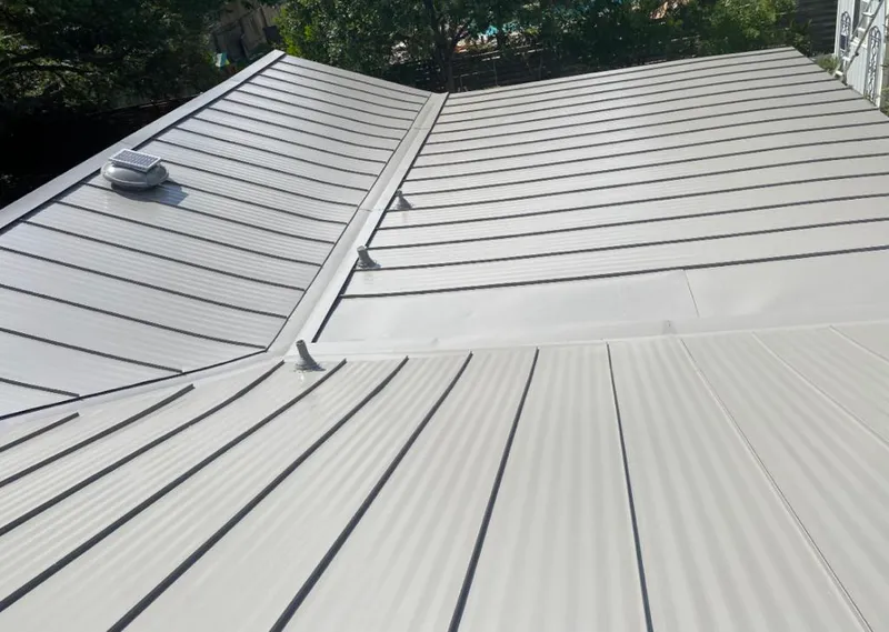 Solar attic fan installed on a metal roof for Roof Ventilation in Neptune Beach